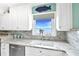 Kitchen sink with granite countertop overlooks the stunning water view at 4722 Independence Dr, Bradenton, FL 34210