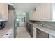 Bright eat-in kitchen with granite countertops, stainless steel appliances, and a laundry area at 4722 Independence Dr, Bradenton, FL 34210