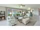 Bright living room with a wall of windows showcasing stunning waterfront views at 4722 Independence Dr, Bradenton, FL 34210