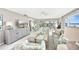 Bright open living room with tile floors, lots of natural light, and scenic waterfront view at 4722 Independence Dr, Bradenton, FL 34210
