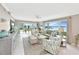 Living room with tile floors, large windows with water views, and comfortable furniture at 4722 Independence Dr, Bradenton, FL 34210