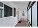 Enclosed porch featuring a pair of red chairs, a welcome message, and outdoor views at 4722 Independence Dr, Bradenton, FL 34210