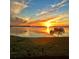 Sunset over the water with brilliant sky reflecting on calm waters at 4722 Independence Dr, Bradenton, FL 34210