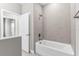 Modern bathroom features a tub with tile surround, shower head, and convenient towel bar at 514 Santiguay St, Punta Gorda, FL 33983