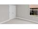 A bedroom with neutral walls, plush carpeting, a window, and a closet door for ample storage at 514 Santiguay St, Punta Gorda, FL 33983