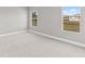 Bright bedroom with plush carpet and large windows that illuminate the neutral interior design at 514 Santiguay St, Punta Gorda, FL 33983
