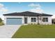 Beautiful single-story home with a well-manicured lawn, blue garage door, and bright white paint at 514 Santiguay St, Punta Gorda, FL 33983