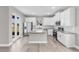 Bright kitchen featuring white cabinetry, stainless steel appliances, granite countertops and island at 514 Santiguay St, Punta Gorda, FL 33983