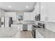 Bright kitchen featuring white cabinetry, stainless steel appliances, granite countertops and island at 514 Santiguay St, Punta Gorda, FL 33983