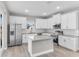 Bright kitchen featuring white cabinetry, stainless steel appliances, granite countertops and island at 514 Santiguay St, Punta Gorda, FL 33983