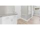 Laundry room boasts granite counters, white cabinets, and wood-look floors for a fresh, modern feel at 514 Santiguay St, Punta Gorda, FL 33983