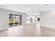 Open floor plan with wood-look flooring and sliding glass doors, creating a bright and airy space at 514 Santiguay St, Punta Gorda, FL 33983
