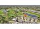 Aerial view of a two-story home located on a cul-de-sac overlooking a golf course and pond at 7812 Birdie Bend Way, Sarasota, FL 34241