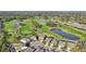 Expansive aerial view displays a community with lush golf course, shimmering lakes, and beautifully landscaped properties at 7812 Birdie Bend Way, Sarasota, FL 34241