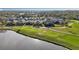Scenic view of a golf course community with homes lining the course and a serene lake at 7812 Birdie Bend Way, Sarasota, FL 34241