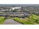 Aerial view featuring waterfront homes with golf course access and lush landscaping at 7812 Birdie Bend Way, Sarasota, FL 34241