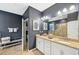 Spacious bathroom features double sinks, granite countertops, and decorative wall art at 7812 Birdie Bend Way, Sarasota, FL 34241