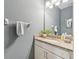 Bathroom features granite countertops, modern fixtures and a decorative mirror for elevated style at 7812 Birdie Bend Way, Sarasota, FL 34241