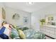 Inviting bedroom with twin beds, shelf decor, and a dresser, perfect for guests or children at 7812 Birdie Bend Way, Sarasota, FL 34241
