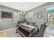 Elegant dining area with modern lighting and backyard access offers a cozy gathering space at 7812 Birdie Bend Way, Sarasota, FL 34241