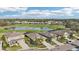 Exterior shot of homes overlooking a golf course with water features, surrounded by mature trees and landscaping at 7812 Birdie Bend Way, Sarasota, FL 34241