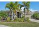 Charming home with a well-manicured lawn, mature trees, and a welcoming front entrance at 7812 Birdie Bend Way, Sarasota, FL 34241