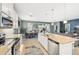 Bright kitchen with stainless appliances opens to the dining area and living room creating an open-concept design at 7812 Birdie Bend Way, Sarasota, FL 34241