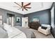 Comfortable main bedroom features a tray ceiling, ceiling fan, and calming paint colors at 7812 Birdie Bend Way, Sarasota, FL 34241