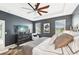 Stylish main bedroom boasts a ceiling fan, neutral color palette, and views of the surrounding landscape at 7812 Birdie Bend Way, Sarasota, FL 34241