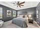 The sophisticated main bedroom boasts a tray ceiling, ceiling fan, and elegant decor at 7812 Birdie Bend Way, Sarasota, FL 34241