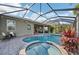 Inviting screened-in pool area with ample seating, lush landscaping, and resort-style appeal at 7812 Birdie Bend Way, Sarasota, FL 34241