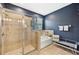 Bright bathroom featuring a glass-enclosed shower, soaking tub, and neutral tilework at 7812 Birdie Bend Way, Sarasota, FL 34241