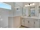 Elegant bathroom featuring a glass-enclosed shower and a white vanity with a large mirror at 12440 Meribel St, Venice, FL 34293