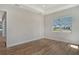 Well-lit bedroom showcasing a large window and light wood flooring at 12440 Meribel St, Venice, FL 34293