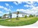 Exterior side view of home with lush green lawn and landscaping at 12440 Meribel St, Venice, FL 34293