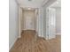 Hallway view featuring luxury vinyl flooring and white trim at 12440 Meribel St, Venice, FL 34293