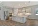 Modern kitchen featuring stainless steel appliances, a center island, and ample cabinet space at 12440 Meribel St, Venice, FL 34293