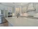 Bright kitchen with white countertops, stainless steel appliances, and a subway tile backsplash at 12440 Meribel St, Venice, FL 34293