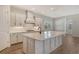 Well-lit kitchen with an island, stainless steel appliances, and lots of counter space at 12440 Meribel St, Venice, FL 34293