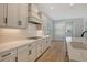 Modern kitchen featuring white cabinets, stainless appliances, and a subway tile backsplash at 12440 Meribel St, Venice, FL 34293