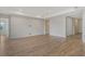 Spacious living room with tray ceilings and light wood flooring throughout at 12440 Meribel St, Venice, FL 34293