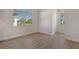 Bright room with wood flooring and a window view of the outdoor landscaping and pool at 12440 Meribel St, Venice, FL 34293