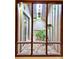 Window view of a private outdoor atrium with plants and stone flooring at 1407 Willow Oak Cir, Bradenton, FL 34209