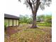 Backyard with mature trees and patio at 1407 Willow Oak Cir, Bradenton, FL 34209