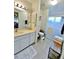 Bright bathroom featuring neutral tile, a shower, and updated vanity with nice lighting at 1407 Willow Oak Cir, Bradenton, FL 34209