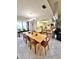 Open dining area with tile floors, a large wooden table, and open access to kitchen at 1407 Willow Oak Cir, Bradenton, FL 34209