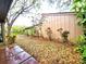 Side view of the home's exterior with mature trees and landscaping at 1407 Willow Oak Cir, Bradenton, FL 34209