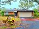 Charming brick home boasts a two-car garage, mailbox, landscaped pathway, and covered front entry at 1407 Willow Oak Cir, Bradenton, FL 34209