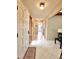 Hallway with bright neutral colors and tile flooring that leads to other areas of the home at 1407 Willow Oak Cir, Bradenton, FL 34209