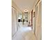 Hallway with white tile flooring and access to multiple rooms at 1407 Willow Oak Cir, Bradenton, FL 34209